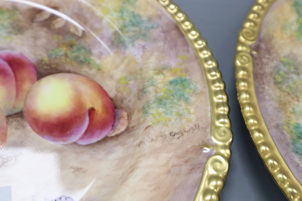 A pair of Aynsley cabinet plates, painted with plums and apples by Paul English, diameter 26cm